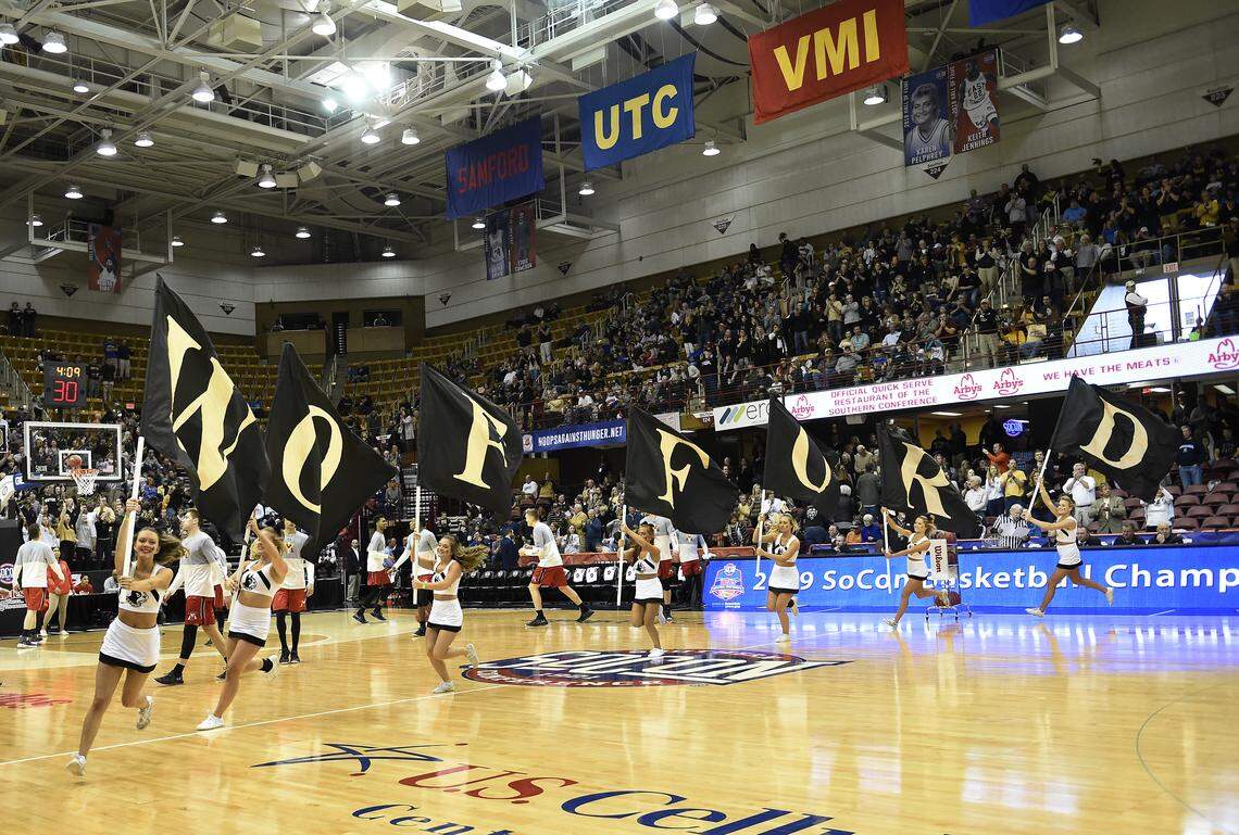 Wofford cheerleaders run team flags around the court before the start of an NCAA college basketball game against Virginia Military for the Southern Conference basketball tournament championship, Saturday, March 9, 2018, in Asheville, N.C.