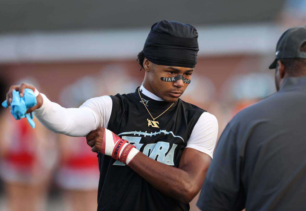 Azel Banag (1) of AC Flora warms up before AC Flora’s game against South Pointe at Memorial Stadium on Friday, September 19, 2025.