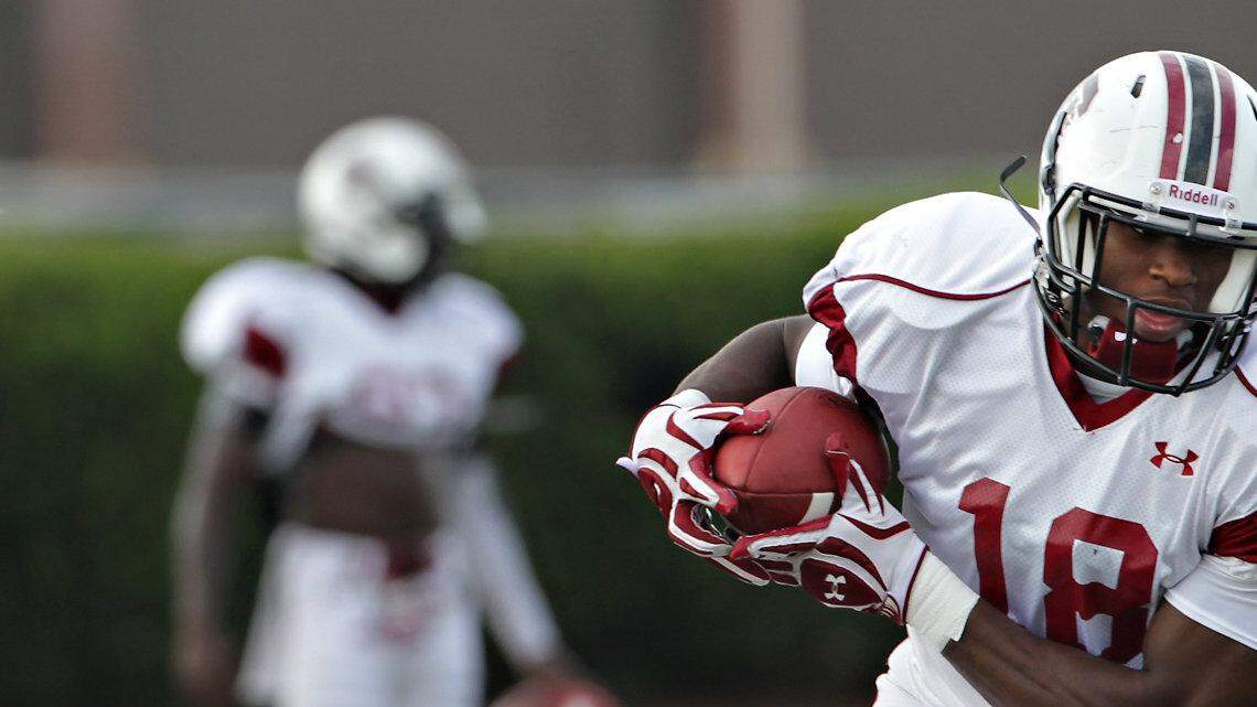 Linebacker Cedrick Cooper moves quickly to intercept the ball during drills.  The USC football team practice Thursday morning on the practice field on Bluff Rd.
