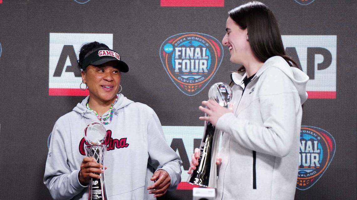 Apr 4, 2024; Cleveland, OH, USA; South Carolina Gamecocks coach Dawn Staley (left) and Iowa Hawkeyes guard Caitlin Clark pose react after being selected as the AP Coach and Player of the Year at a press conference at Rocket Mortgage FieldHouse.