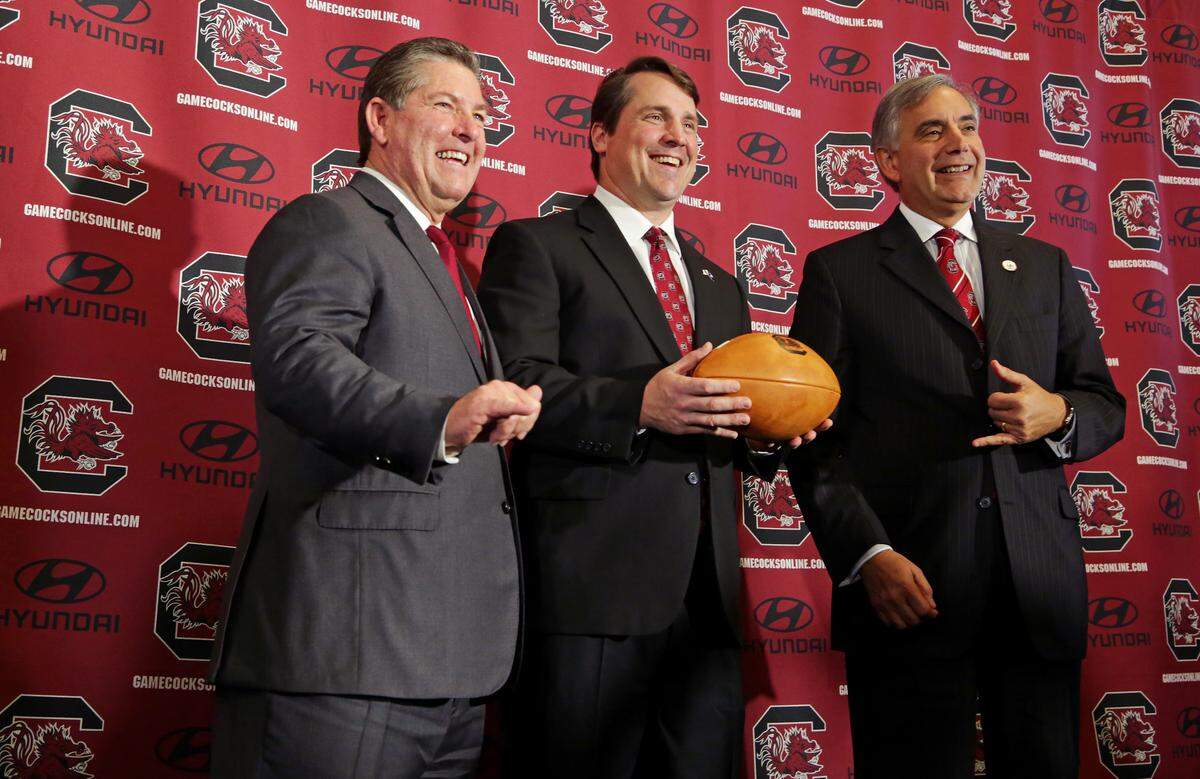 From Dec. 7, 2015: USC’s athletic director Ray Tanner, left, and president Harris Pastides, right, take a photo with new head football coach Will Muschamp.