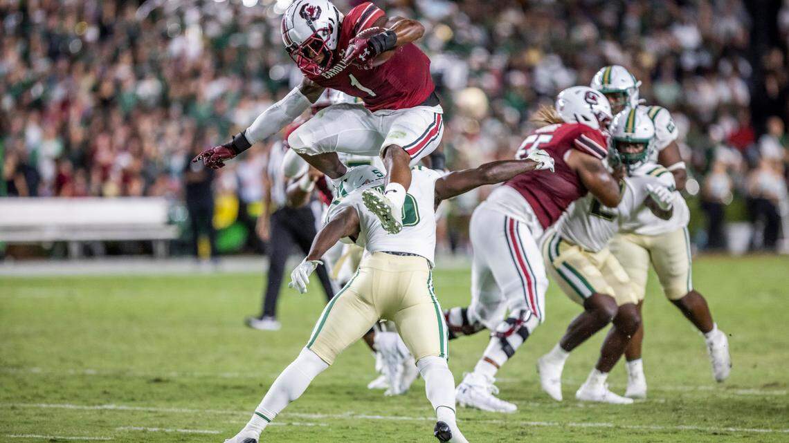 South Carolina running back MarShawn Lloyd (1) hurdles safety Wayne Jones of the University of North Carolina at Charlotte at Williams-Brice Stadium in Columbia, SC on Saturday, Sept. 24, 2022.