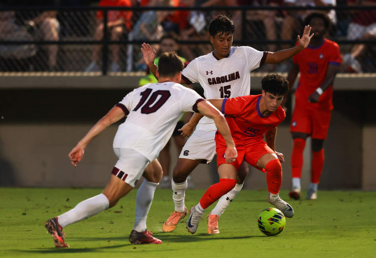South Carolina defender Alejandro Velazquez-Lopez (15) and forward Ethan Ballek (10) defend Clemson midfielder Nathan Richmond (25) during the Gamecocks’ game against Tigers in Columbia on Friday, August 30, 2024.