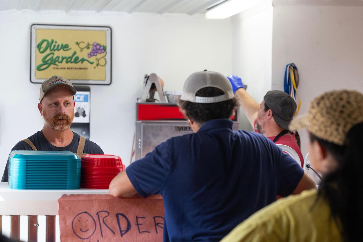 Robbie Robinson, left, serves customers at City Limits Barbeque in West Columbia, South Carolina on Saturday, October 7, 2023.