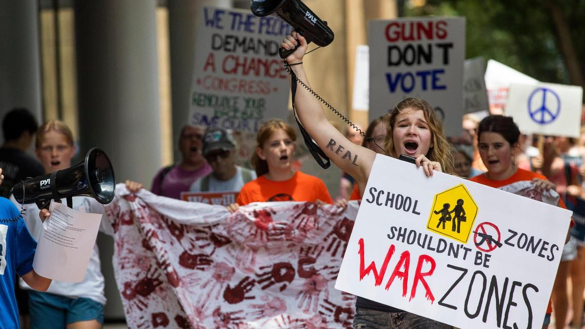 Protestors walk through Soda City Market and chant in support of gun control measures in Columbia, South Carolina on Saturday, June 11, 2022.