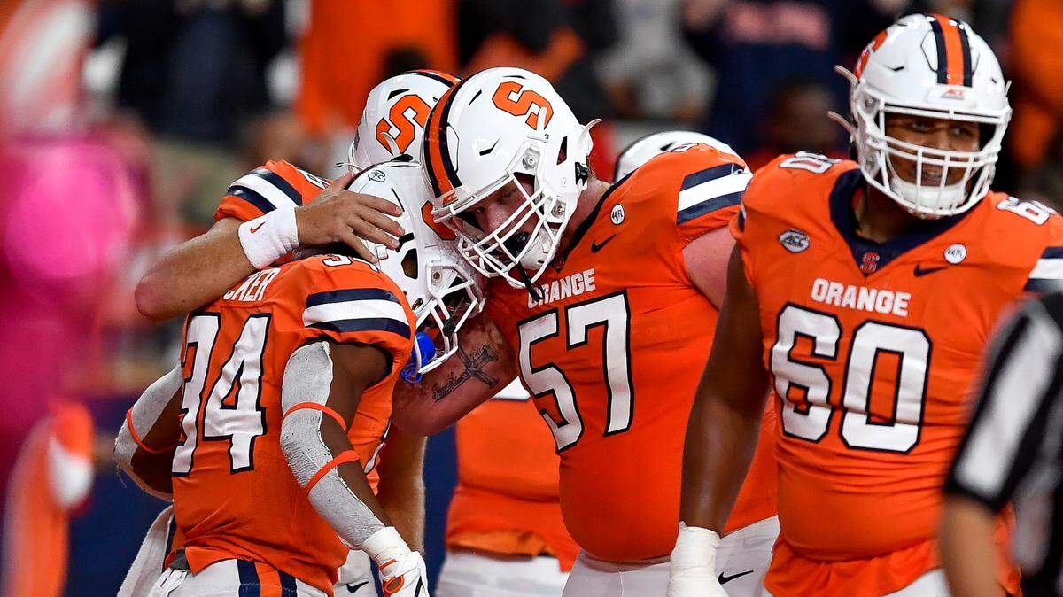 Syracuse running back Sean Tucker, left, celebrates with offensive lineman Dakota Davis (57) after scoring a touchdown against Wake Forest during the first half of an NCAA college football game in Syracuse, N.Y., Saturday, Oct. 9, 2021.
