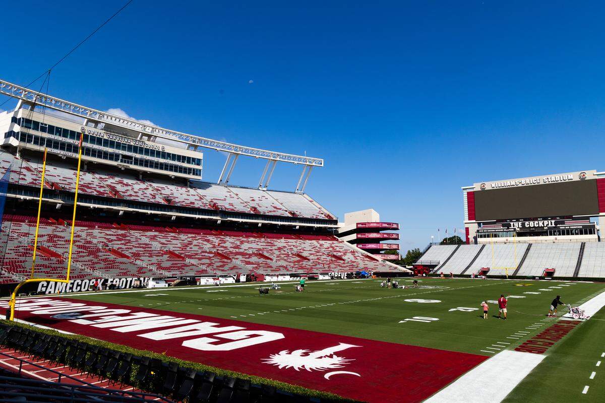 Workers at the University of South Carolina paint the field at Williams-Brice Stadium on Friday, September 12, 2025.