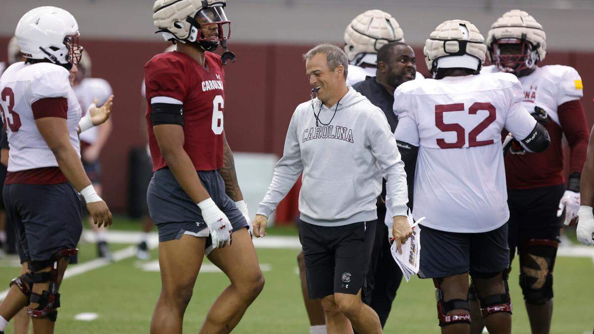Head Coach Shane Beamer walks between players during spring practice inside the Jerri and Steve Spurrier Indoor Practice Facility on Thursday, April, 11, 2024.