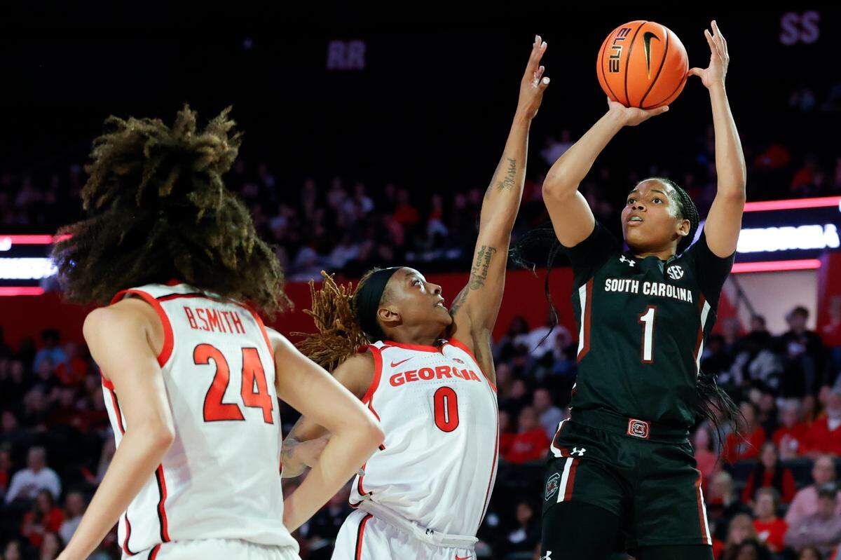 South Carolina guard Zia Cooke, right, shoots over Georgia forward Zoesha Smith during the second half of an NCAA college basketball game in Athens, Ga., Monday, Jan. 2, 2023. (AP Photo/Alex Slitz)