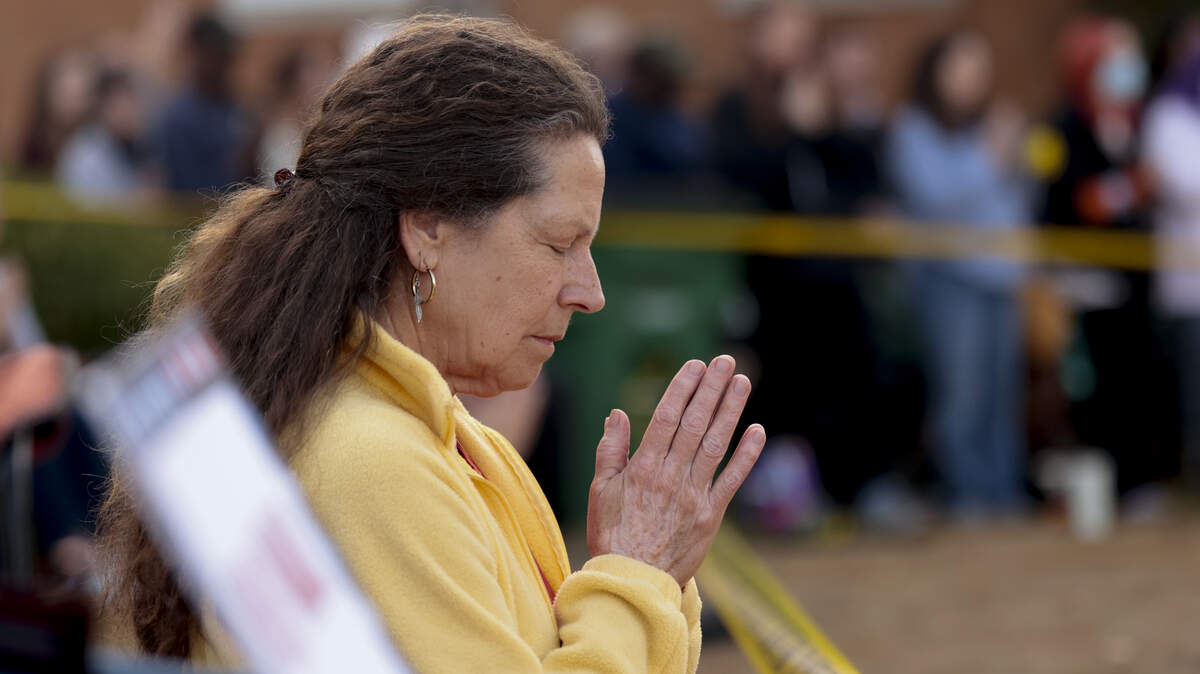 Dana Hawthorne prays on Thursday, Jan. 8, 2026, with the Buddhist monks with the Walk for Peace. The group stopped at the Saluda County Courthouse on their 2,300-mile walk across the country.