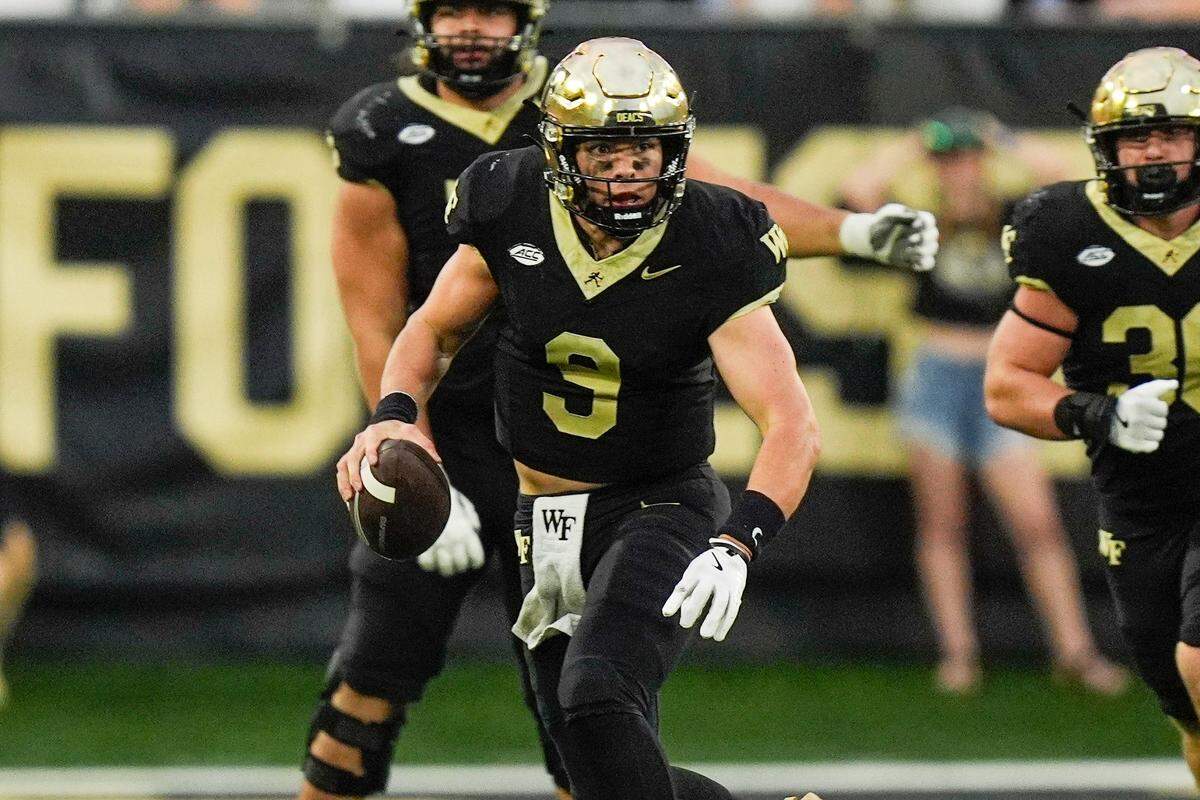 Sep 28, 2024; Winston-Salem, North Carolina, USA; Wake Forest Demon Deacons quarterback Hank Bachmeier (9) keeps the ball for a run against the Louisiana-Lafayette Ragin Cajuns during the second half at Allegacy Federal Credit Union Stadium.