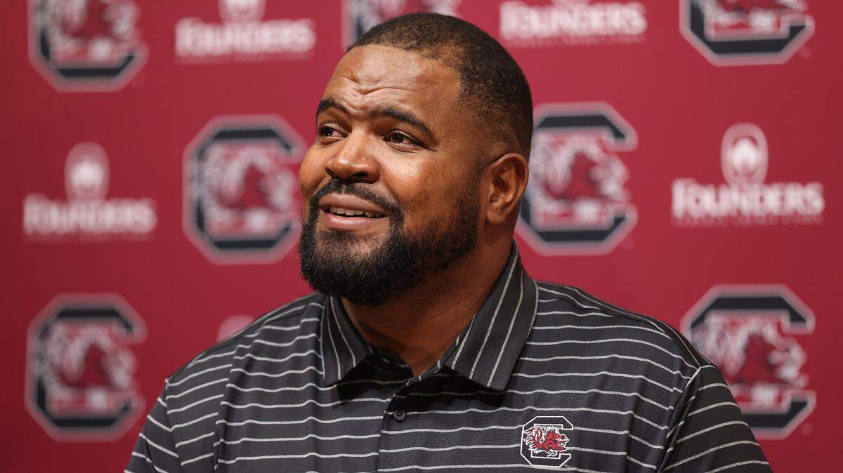 The Gamecocks’ new defensive line coach Travian Robertson laughs after being introduced by head coach Shane Beamer during a press conference held Tuesday, May 2, 2023.