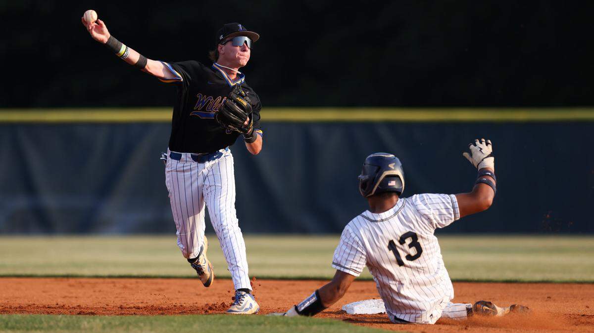 Amare Counts (13) of Blythewood tries to break up a double play as Graham Coleman (6) of Lexington makes the throw to first during Game 1 of the Class 5A Upper State championship series in Columbia on Tuesday, May 20, 2025.