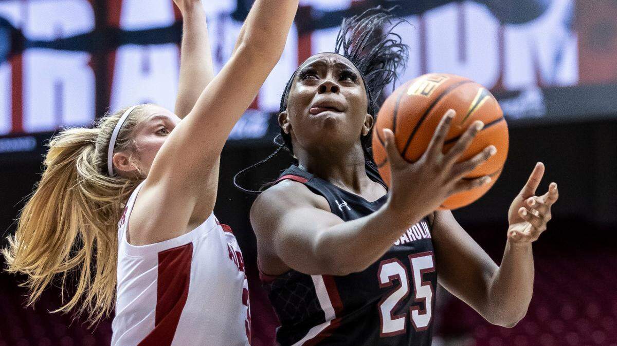 South Carolina guard Raven Johnson (25) penetrates past Alabama guard Sarah Ashlee Barker (3) and scores during the first half of an NCAA college basketball game, Sunday, Jan. 29, 2023, in Tuscaloosa, Ala.