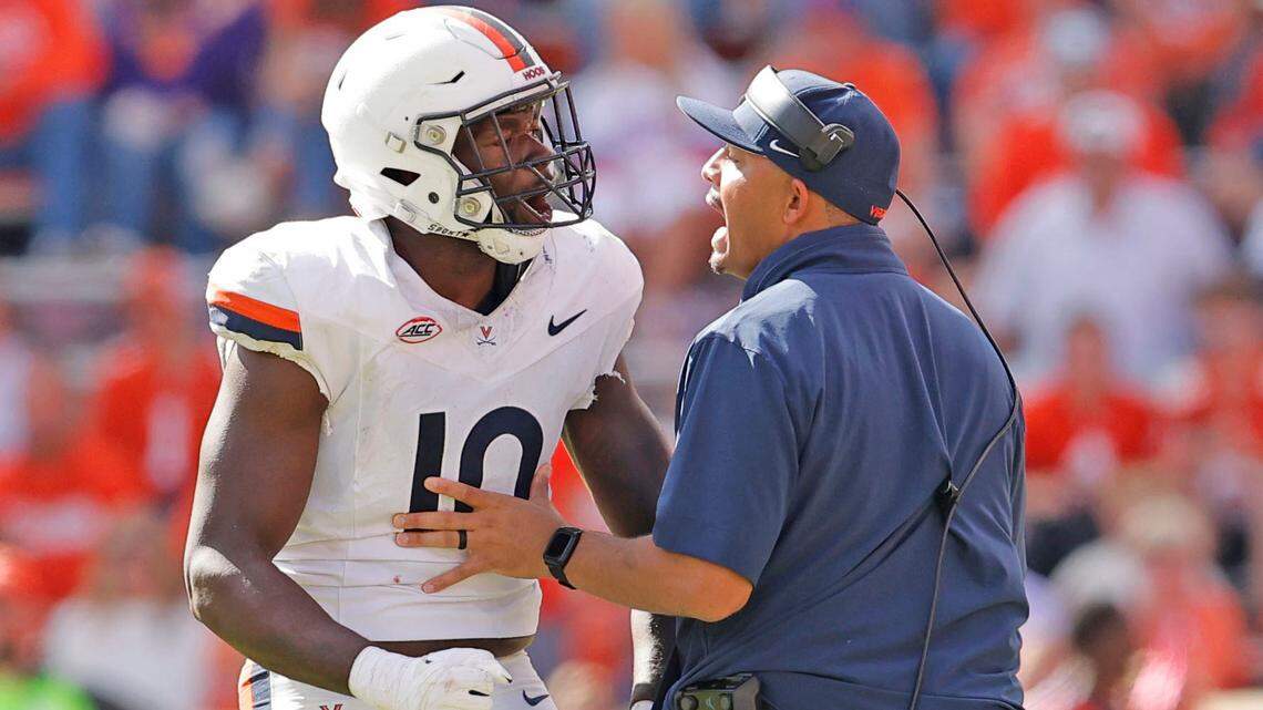 Virginia defensive end Ben Smiley III (10) gets a word or two from Virginia head coach Tony Elliott after being involved in a fight with Clemson during second-half action in Clemson, S.C. on Saturday, Oct. 19, 2024.