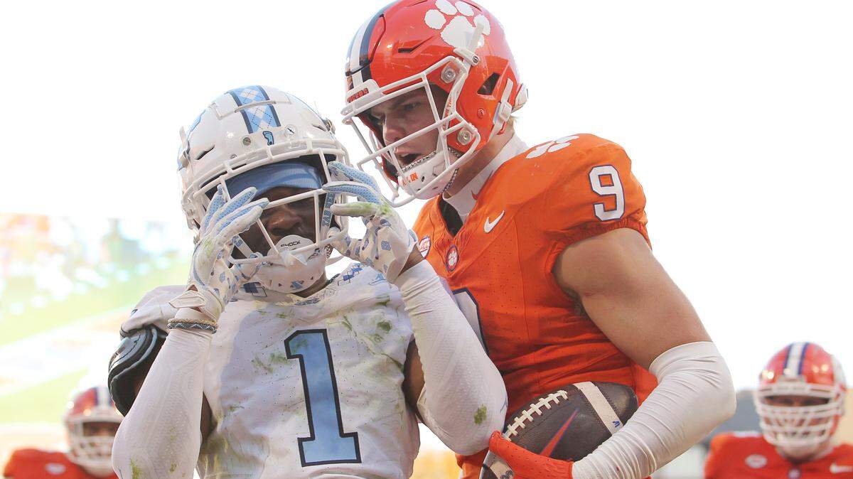 Clemson tight end Jake Briningstool (9) lets North Carolina defensive back Antavious Lane (1) know what he thinks of his coverage after catching a touchdown pass over him during first-half action in Clemson, S.C. on Saturday, Nov.18, 2023.
