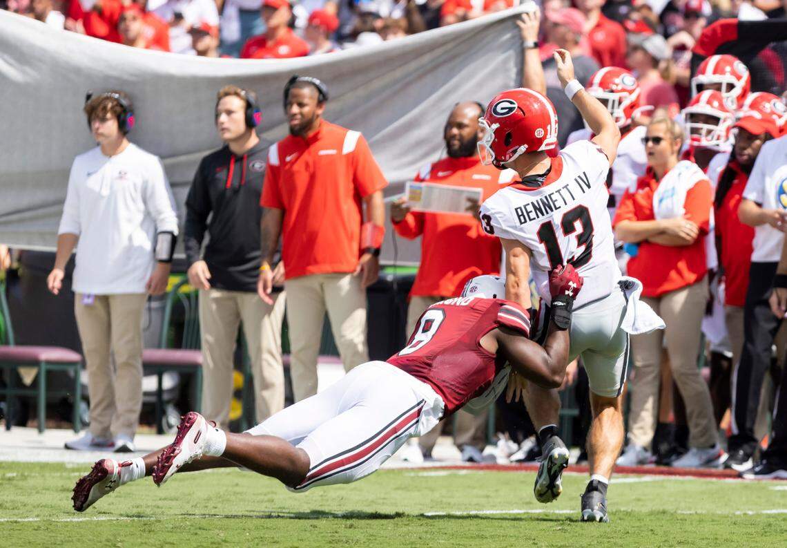 South Carolina edge Gilber Edmond (8) makes a diving tackle as University of Georgia quarterback Stetson Bennett (13) makes a pass at Williams-Brice Stadium in Columbia, SC on Saturday, Sept. 17, 2022.