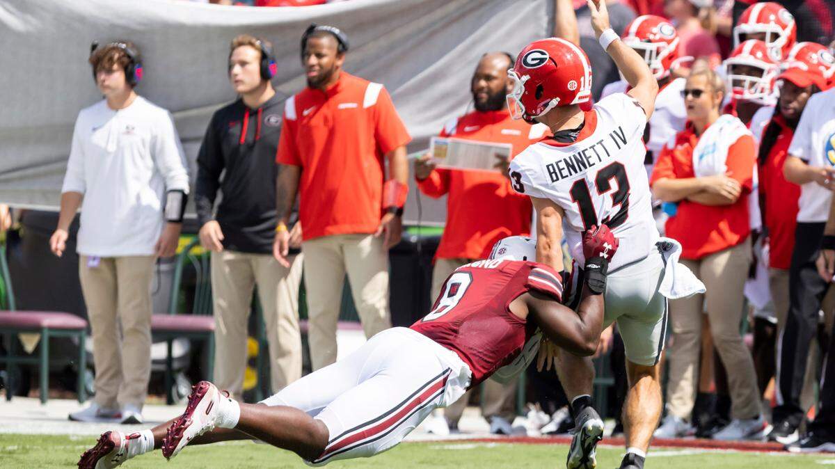 South Carolina edge Gilber Edmond (8) makes a diving tackle as University of Georgia quarterback Stetson Bennett (13) makes a pass at Williams-Brice Stadium in Columbia, SC on Saturday, Sept. 17, 2022.
