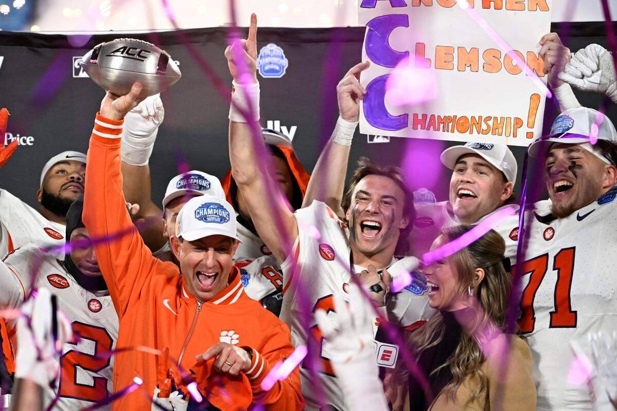Dec 7, 2024; Charlotte, NC, USA; Clemson Tigers head coach Dabo Swinney, quarterback Cade Klubnik (2) and teammates celebrate after winning the 2024 ACC Championship game against the Southern Methodist Mustangs at Bank of America Stadium.