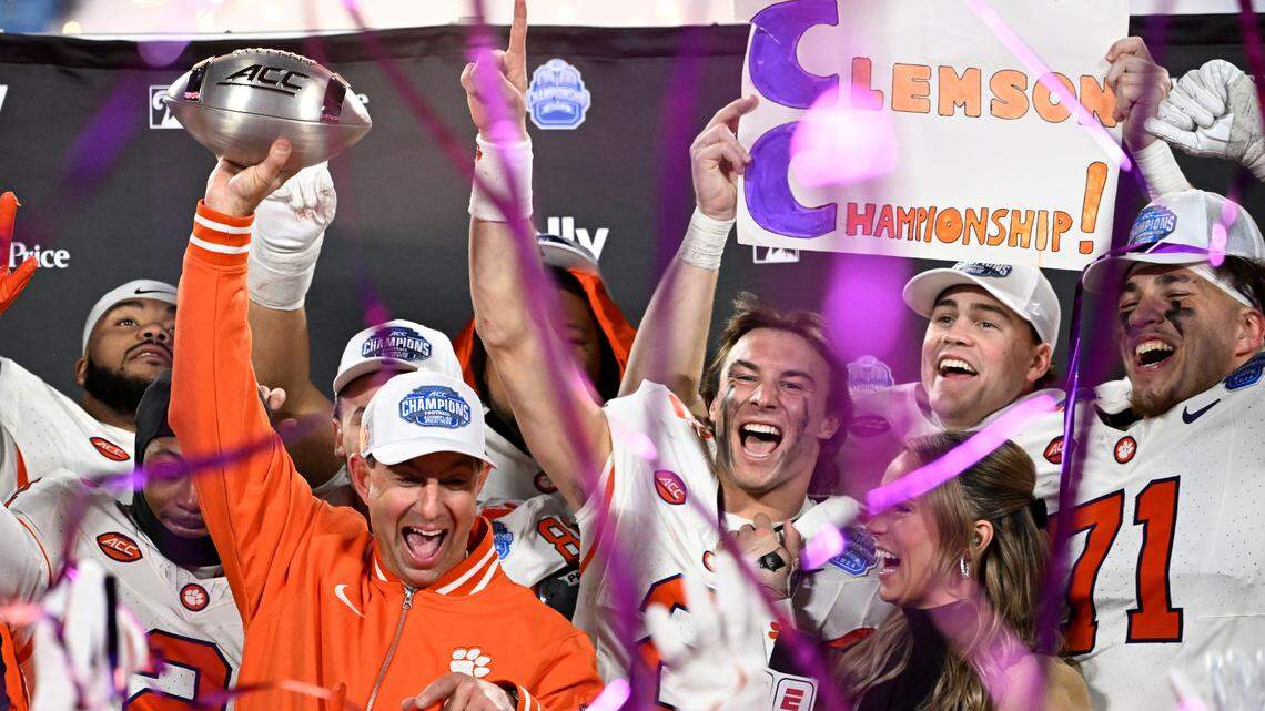 Dec 7, 2024; Charlotte, NC, USA; Clemson Tigers head coach Dabo Swinney, quarterback Cade Klubnik (2) and teammates celebrate after winning the 2024 ACC Championship game against the Southern Methodist Mustangs at Bank of America Stadium.