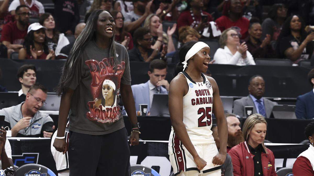 South Carolina's Adhel Tac wears a Raven Johnson T-shirt as Raven Johnson (25) cheers on the team during the second half of action of their Sweet 16 women's basketball game against Oklahoma at Golden 1 Arena on Saturday, March 28, 2026.