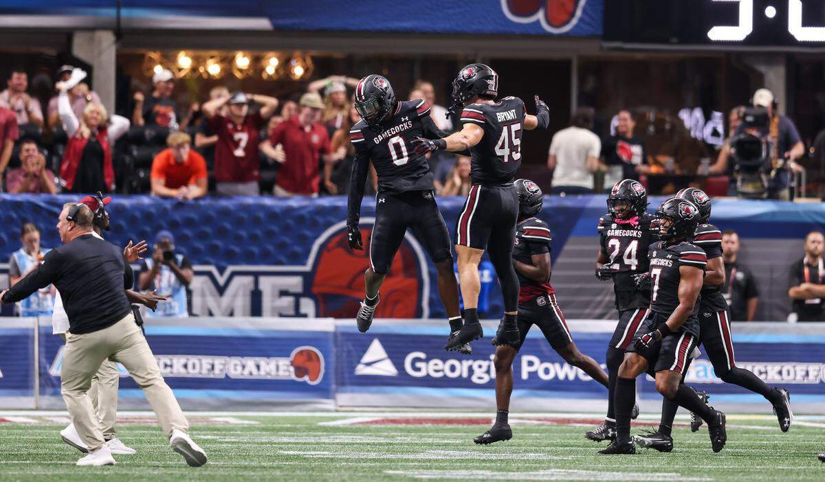 South Carolina linebacker Fred Johnson (0) celebrates with linebacker Colin Bryant (45) after a turnover Sunday at Mercedes-Benz Stadium in Atlanta. The Gamecocks and Hokies faced off Aug. 31 in the 2025 Aflac Kickoff Game.