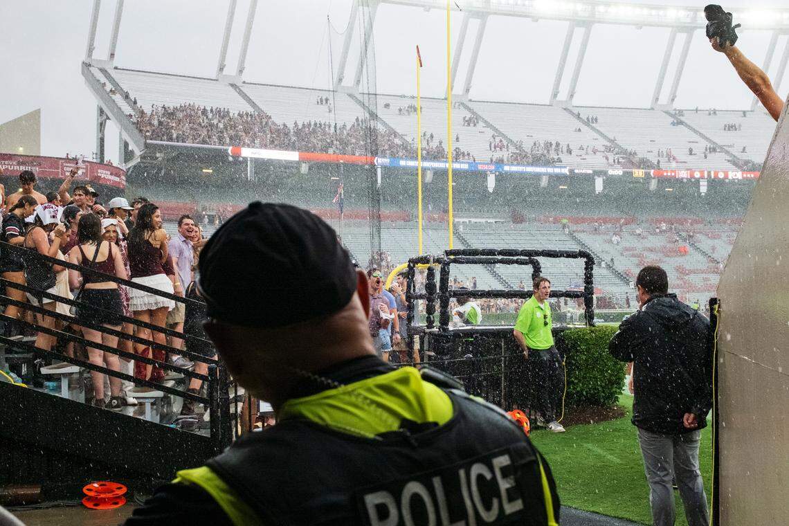The South Carolina student section sticks out the heavy rain and weather delay Saturday.