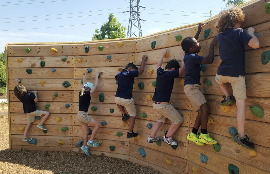 A climbing wall is included in one of the three playgrounds at Greenville’s new Unity Park.