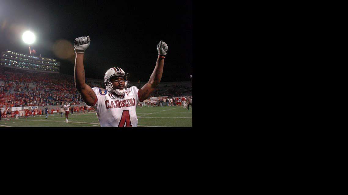 Sidney Rice, from Gaffney, S.C., raises his arms in victory toward the South Carolina sideline after USC defeated Houston 44-36 in the AutoZone Liberty Bowl on Dec. 29, 2006.