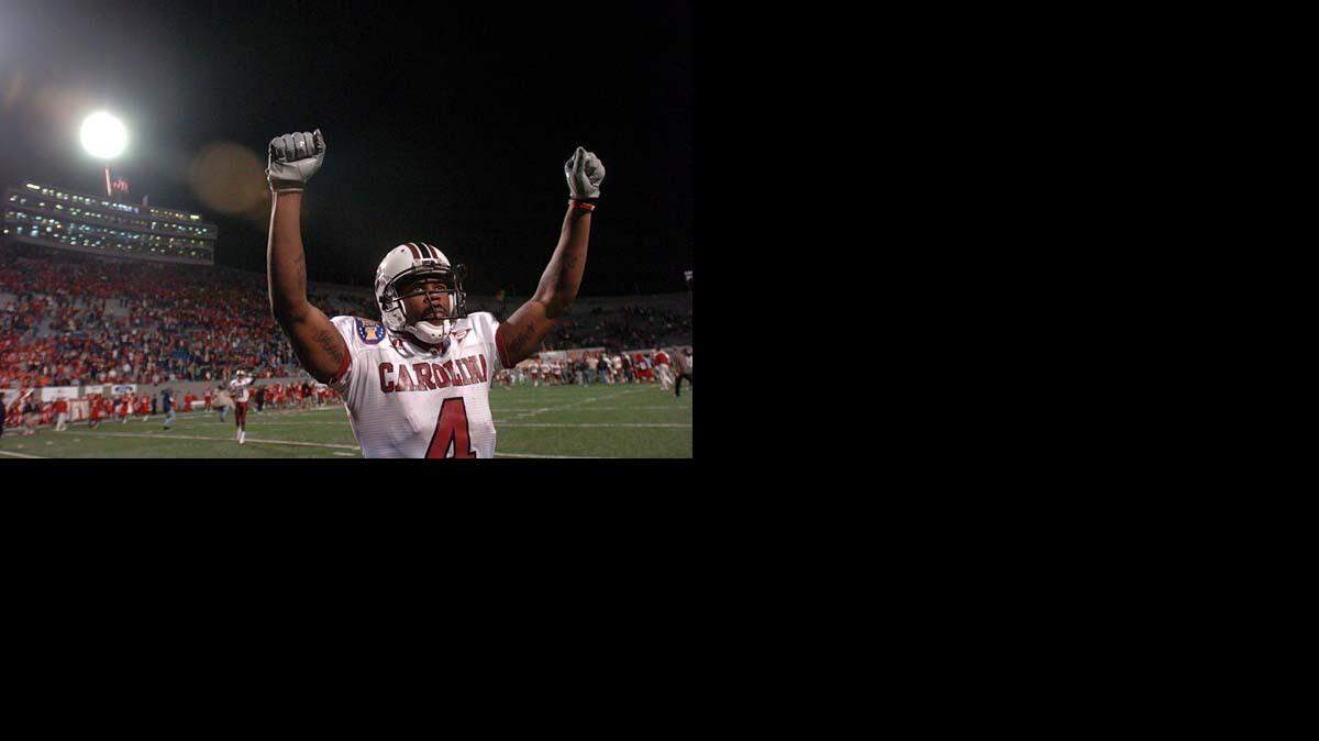 Sidney Rice, from Gaffney, S.C., raises his arms in victory toward the South Carolina sideline after USC defeated Houston 44-36 in the AutoZone Liberty Bowl on Dec. 29, 2006.