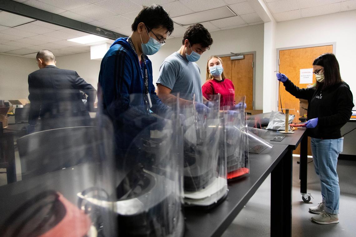 Students at the University of South Carolina make face shields for medical workers at the Photonics and Microelectronics Laboratory at the university on Wednesday, April 1, 2020. The shields feature a 3D printed visor and can be sanitized and reused.