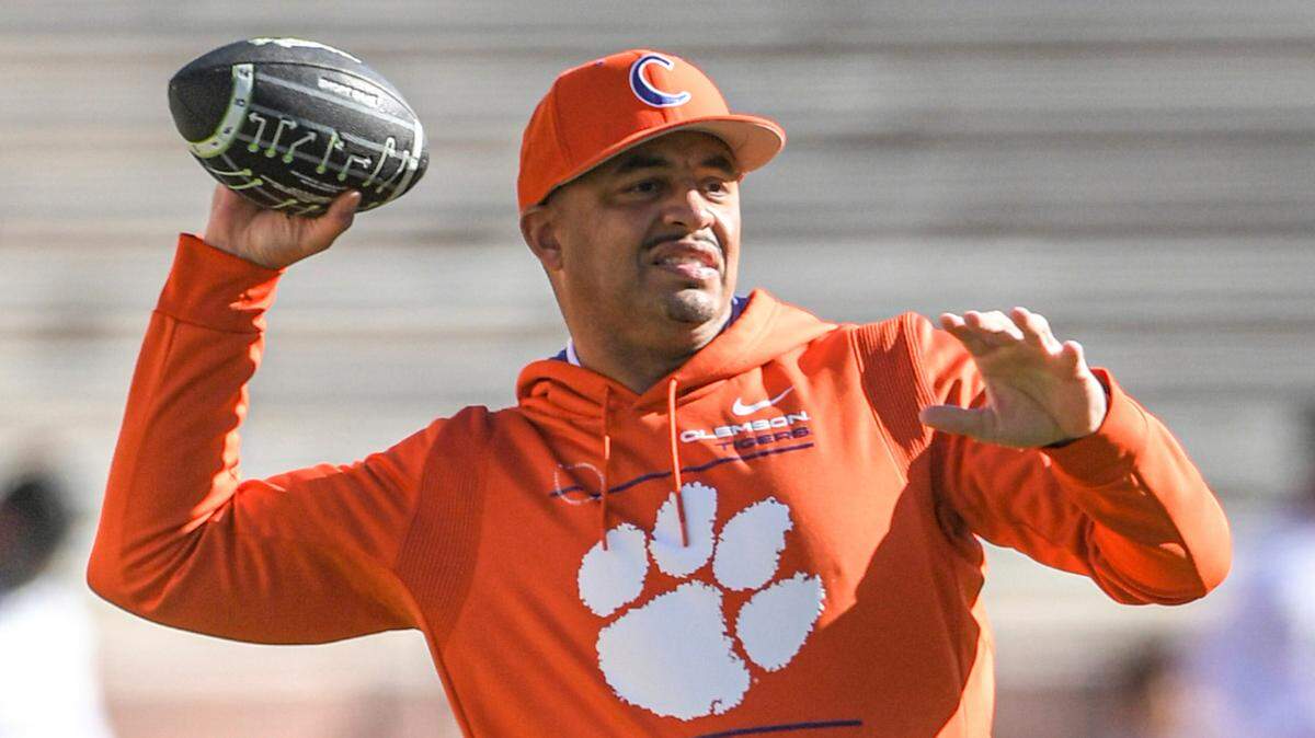 FILE - Clemson offensive coordinator Tony Elliott throws a ball as players warm up before an NCAA college football game with Wake Forest at Memorial Stadium in Clemson, S.C., on Nov. 20, 2021. Virginia has hired Elliott as its next football coach, Cavaliers athletic director Carla Williams announced Friday, Dec. 10, 2021.