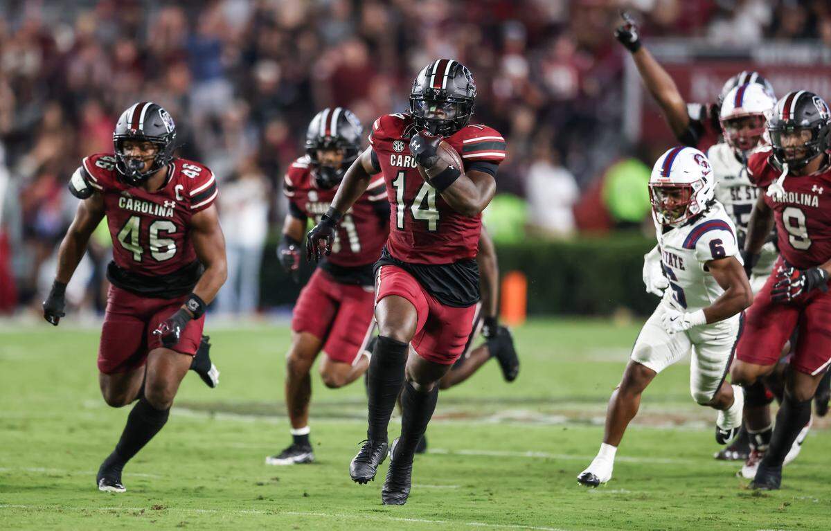 South Carolina linebacker Jaron Willis (14) carries the ball in for a touchdown following an interception during the Gamecocks’ game against South Carolina State at Williams-Brice Stadium in Columbia on Saturday.