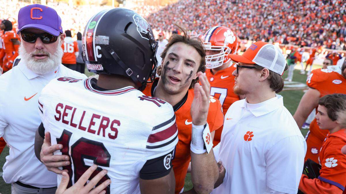 South Carolina quarterback LaNorris Sellers (16) is congratulated by Clemson quarterback Cade Klubnik (2) after the Palmetto Bowl between at Memorial Stadium in Clemson on Saturday, November 30, 2024.



