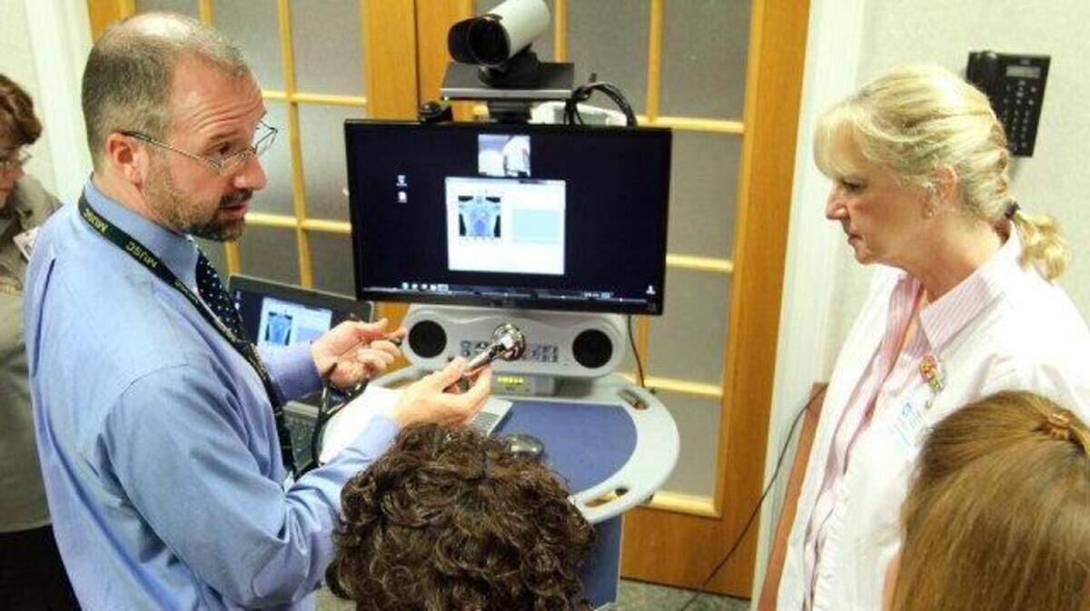 Dr. David McSwain of MUSC demonstrates the telemedicine stethoscope to the staff at Georgetown Memorial Hospital.