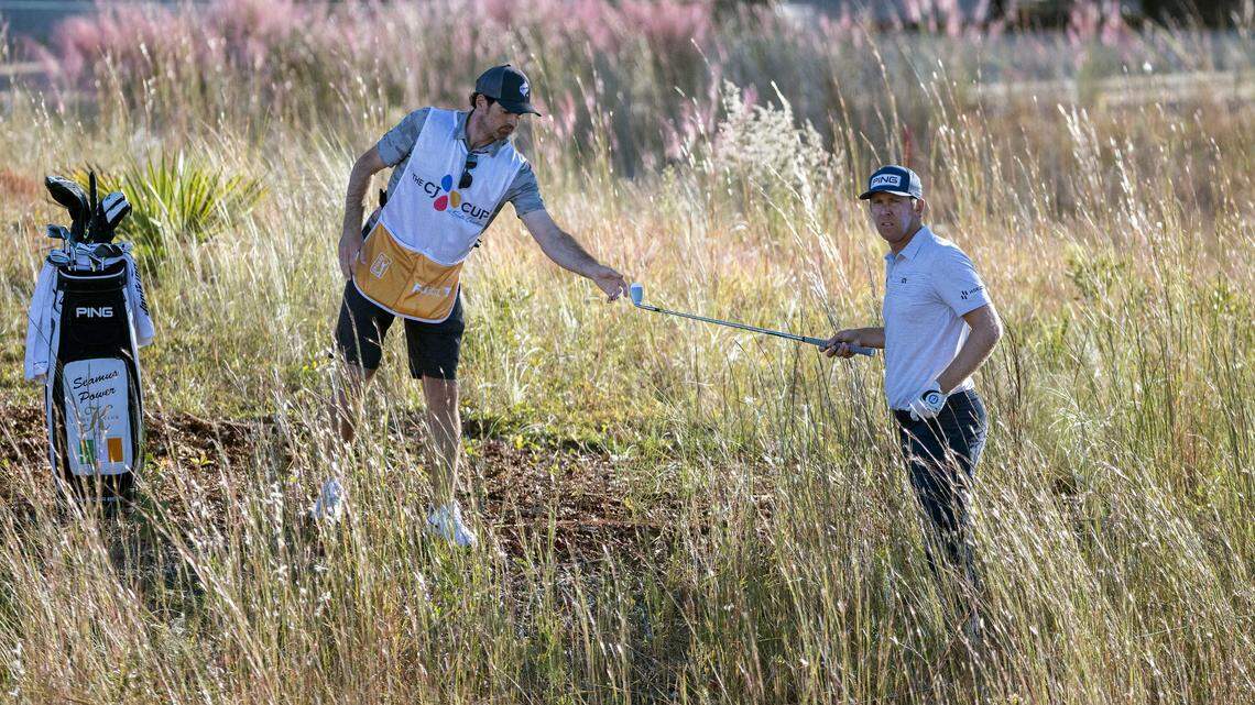 Seamus Power, right, of Ireland, takes a club from his caddie Simon Keelan, left, before hitting out of the rough at the 18th green during the first round of the CJ Cup golf tournament Thursday.