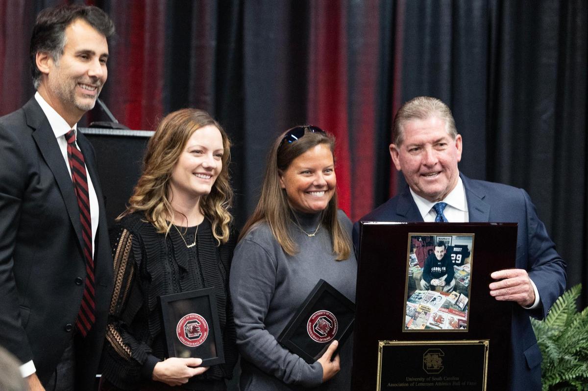Family members of Tommy Moody, a Gamecocks commentator and supporter of the University of South Carolina’s athletics program, receive Letterman Association patches after Moody is posthumously inducted into the university’s hall of fame at Williams-Brice Arena on Friday, November 1, 2024.