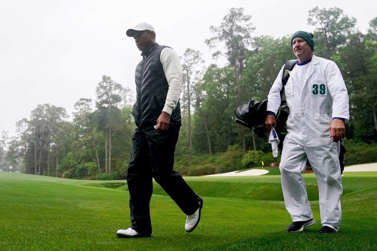 Tiger Woods walks to the 14th tee with caddie Joe LaCava during the second round of The Masters golf tournament.