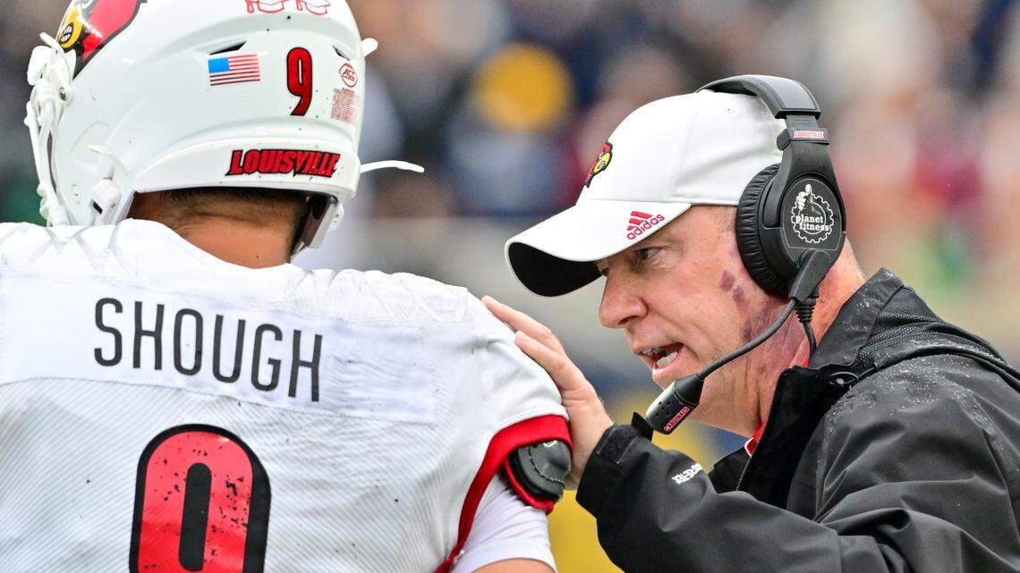 Sep 28, 2024; South Bend, Indiana, USA; Louisville Cardinals head coach Jeff Brohm talks to quarterback Tyler Shough (9) in the second quarter against the Notre Dame Fighting Irish at Notre Dame Stadium.