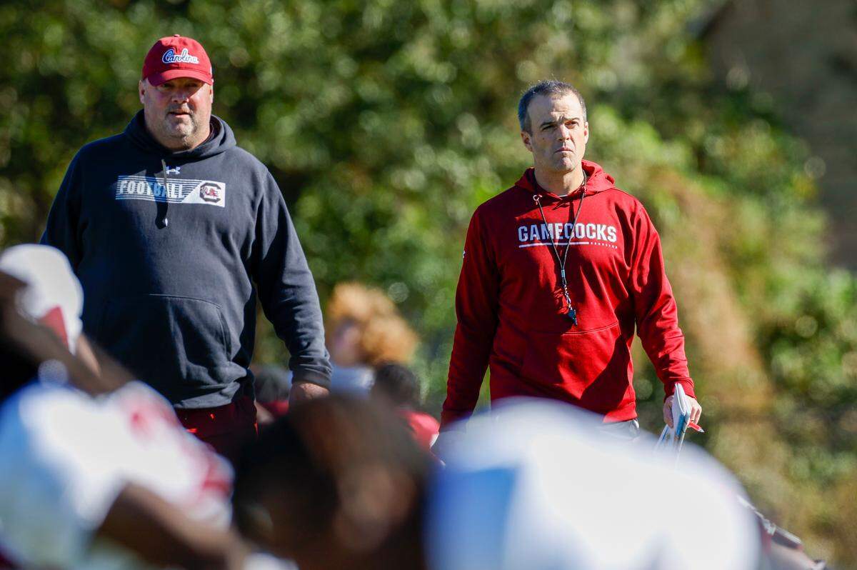 Freddie Kitchens (left) and Shane Beamer (right) at South Carolina’s practice Tuesday, Dec. 27, 2022 at Episcopal School of Jacksonville in preparation for the Gator Bowl.