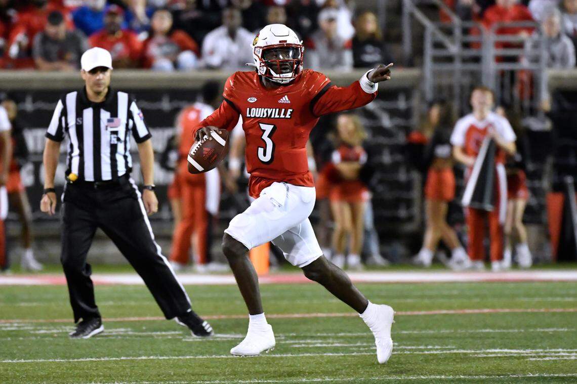 Louisville quarterback Malik Cunningham (3) gestures to receivers as he scrambles during the first half of the team’s NCAA college football game against Pittsburgh in Louisville, Ky., Saturday, Oct. 22, 2022. (AP Photo/Timothy D. Easley)