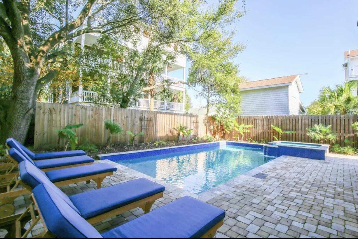 A view of the private pool and hot tub behind a luxury vacation home rental in Isle of Palms.