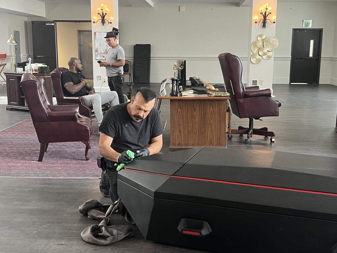 A crew member for the new action film “Straight Shot” polishes a prop coffin on set at 1208 Washington St. in downtown Columbia on Aug. 13, 2025.
