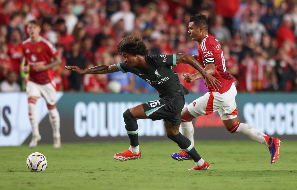 Liverpool forward Harvey Blair (86) pushes past Manchester United midfielder Casemiro (18) during the Rivals in Red International Friendly soccer match between Manchester United and Liverpool in Columbia on Saturday, August 3, 2024.
