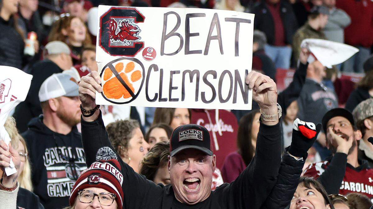A South Carolina fan holds up a Beat Clemson sign during Saturday’s game against Wofford at Williams-Brice Stadium.