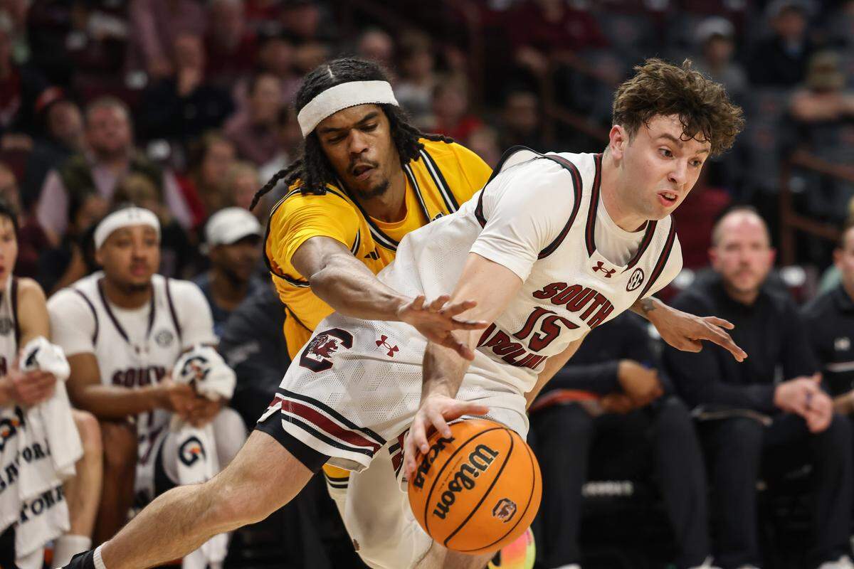 South Carolina guard Eli Ellis (15) is defended by Southern Mississippi guard Isaac Taveras (10) during the men's basketball game against Southern Mississippi at Colonial Life Arena on Sunday, Nov. 9, 2025.