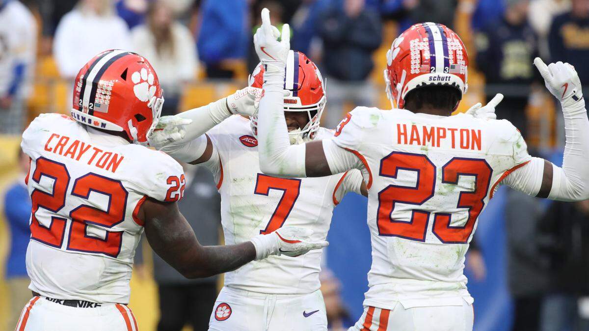 Nov 16, 2024; Pittsburgh, Pennsylvania, USA; Clemson Tigers safety Khalil Barnes (7) celebrates his game clinching interception as time ran out with linebacker Dee Crayton (22) and cornerback Ashton Hampton (23) against the Pittsburgh Panthers during the fourth quarter at Acrisure Stadium.