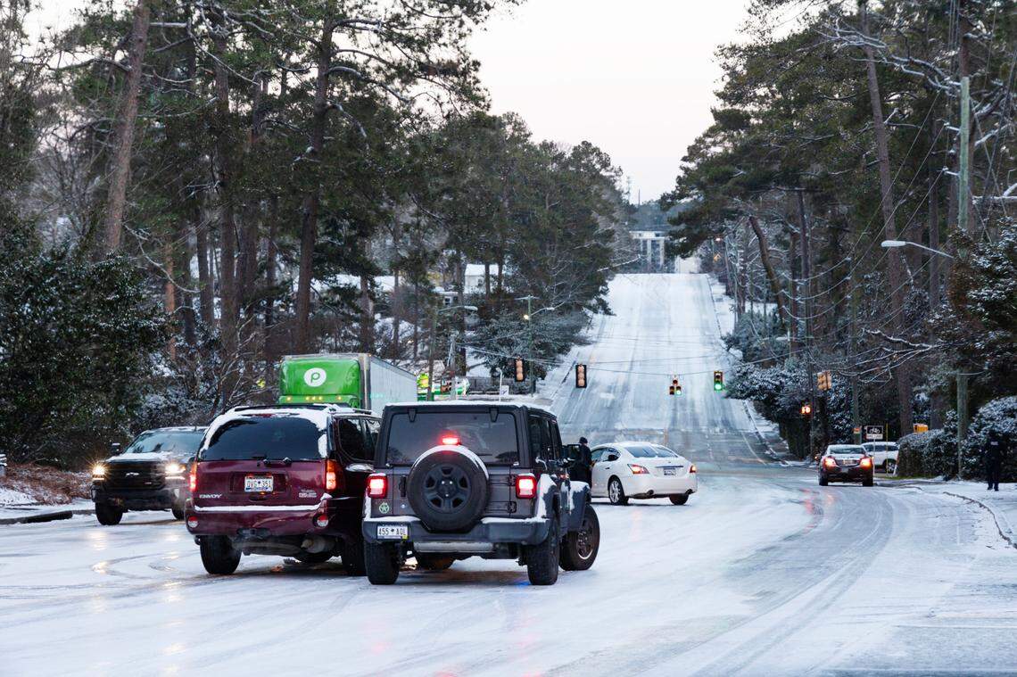 Drivers are stuck on Beltline Boulevard near Trenholm Road in Columbia, South Carolina on Wednesday, January 22, 2025. Police did not block the top of the blind hill, but did help drivers navigate to safety after their wrecks.