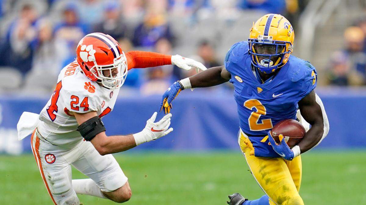 Pittsburgh running back Israel Abanikanda (2) gets away from Clemson safety Nolan Turner (24) on a run during the first half of an NCAA college football game, Saturday, Oct. 23, 2021, in Pittsburgh. (AP Photo/Keith Srakocic)