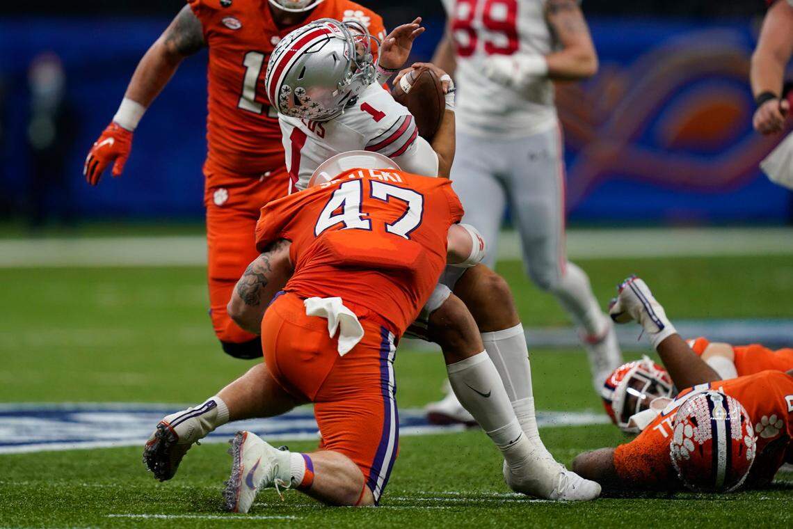 Ohio State quarterback Justin Fields gets hit by Clemson linebacker James Skalski during the first half of the Sugar Bowl NCAA college football game Friday, Jan. 1, 2021, in New Orleans. Skalski was ejected from the game for targeting. (AP Photo/Gerald Herbert)